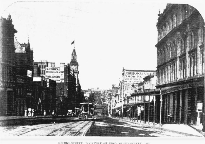 1897 Bourke Street looking towards Parliament. 
John Danks & Son hardware, Harry Guy's long time employer. Probably where McEwans hardware later stood for many years.
G.P.O. on left with oncoming cable tram.

Image: Australasian June 05 p27