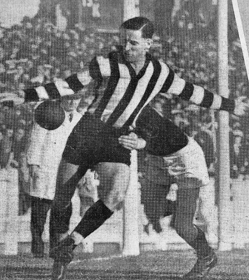 This image shows Collingwood full-back Jack Regan getting a clearing kick away, but his Carlton opponent, "Soapy" Vallence, had the better of their duel, and kicked 8 goals. 